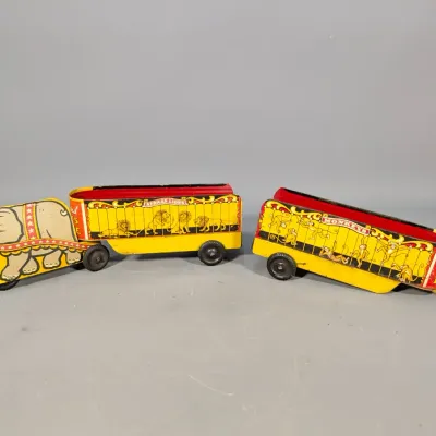 Sale Photo Thumbnail #278: Vintage tin litho circus train toy featuring an elephant-shaped cab pulling 'African Lions' and 'Monkeys' animal wagons.