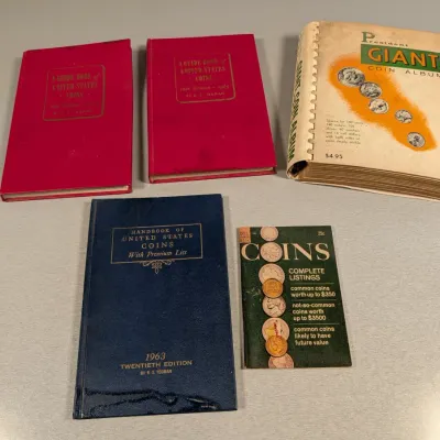 Sale Photo Thumbnail #21: Collection of vintage coin collecting books and albums, including R.S. Yeoman's "A Guide Book of United States Coins" red books, a 1963 blue handbook, and a President Giant Coin Album.