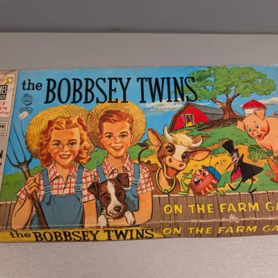 Sale Photo Thumbnail #348: Vintage 1957 Milton Bradley 'The Bobbsey Twins On the Farm Game' featuring colorful illustrated box art in fair condition with edge wear.