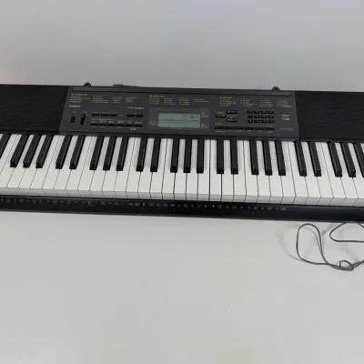 Sale Photo Thumbnail #39: Casio CTK-2080 61-key electronic portable keyboard with power adapter, featuring built-in speakers and LCD screen.