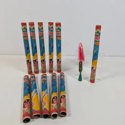 Sale Photo Thumbnail #52: Collection of vintage Parachute fireworks tubes and a plastic parachute figure with launcher, made in Taiwan.