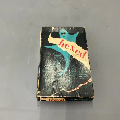 Sale Photo Thumbnail #207: Vintage Tryne Games 'It's Hexed' Jinx Jigsaw Puzzle No. 115, featuring a ghost illustration on a black box with visible wear.