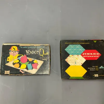 Sale Photo Thumbnail #274: Two vintage Tryne jigsaw puzzle games, including Kwazy Quilt and Jinxed, in their original graphic boxes.