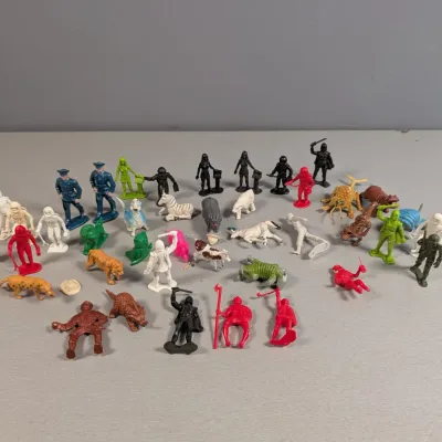 Sale Photo Thumbnail #433: Collection of vintage plastic toy figurines, including military figures, knights, animals, and sci-fi characters in various colors.