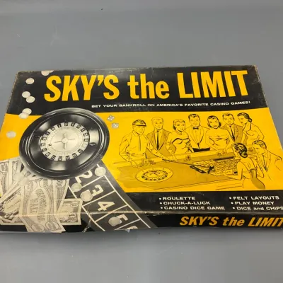 Sale Photo Thumbnail #238: Vintage Sky's the Limit casino-style board game box featuring roulette, chuck-a-luck, and dice games, showing edge wear and creasing.