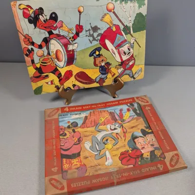 Sale Photo Thumbnail #338: Vintage Jaymar cartoon inlay puzzles, including a Crusader Rabbit inlaid tray puzzle and a boxed 4-puzzle Bugs Bunny set, showing light age-appropriate wear.