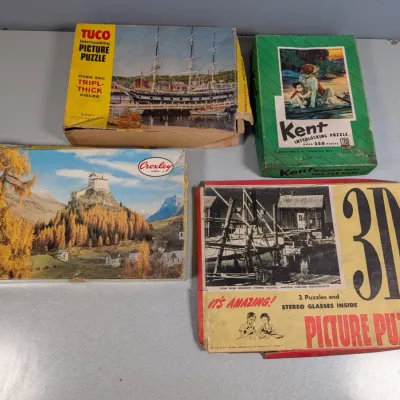 Sale Photo Thumbnail #203: Collection of four vintage jigsaw puzzles in original boxes, including brands like Tuco, Kent, Milton Bradley, and a 3D picture puzzle.