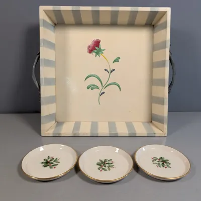 Sale Photo Thumbnail #131: Hand-painted wooden serving tray with striped borders and a central flower motif, paired with three porcelain Lenox holiday coasters.