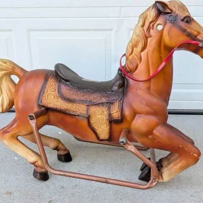 Sale Photo Thumbnail #160: Vintage Wonder Horse spring rocking horse featuring a molded plastic body with a detailed western saddle and metal frame, showing light surface wear.