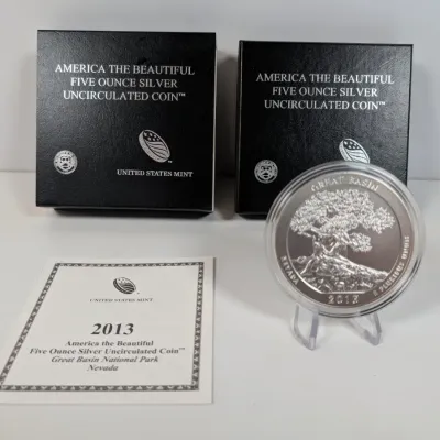 Sale Photo Thumbnail #10: 2013 America the Beautiful Great Basin National Park five-ounce silver uncirculated coin, accompanied by its original United States Mint presentation boxes and certificate of authenticity.