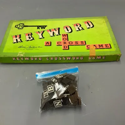 Sale Photo Thumbnail #115: Vintage 1953 Parker Brothers "Keyword: A Crossword Game" board game in its original green box, accompanied by a plastic bag of letter tiles.