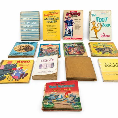 Sale Photo Thumbnail #429: Collection of vintage books including children's titles like Dr. Seuss's The Foot Book, Bozo, Woody Woodpecker, along with non-fiction titles, showing age-appropriate wear.