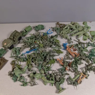 Sale Photo Thumbnail #381: Large collection of vintage plastic army men figures and military vehicles in various sizes and colors.