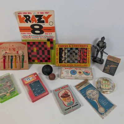 Sale Photo Thumbnail #387: Collection of vintage mid-century novelties, pocket games, and toys including Krazy 8 Checkerboard, Old Maid card game, and a miniature knight figurine.
