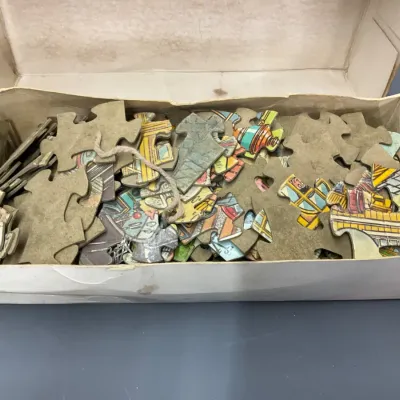 Sale Photo Thumbnail #113: Vintage jigsaw puzzle pieces with colorful illustrations stored loose inside a original cardboard box.