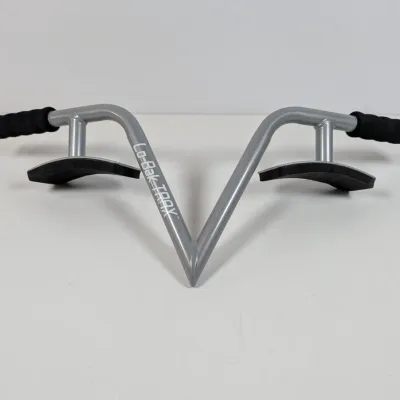 Sale Photo Thumbnail #31: Lo-Bak Trax portable spinal traction device in silver metal with black foam padded grips and thigh pads.