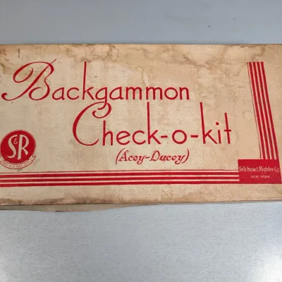 Sale Photo Thumbnail #197: Vintage Selchow & Righter Backgammon Check-o-kit box showing moderate age staining along the lid.