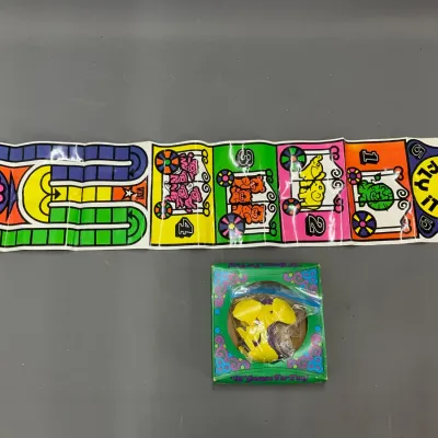 Sale Photo Thumbnail #228: Vintage 'Flip & Fly It' psychedelic children's board game with original box, fold-out paper track, and yellow playing pieces, circa 1970s.