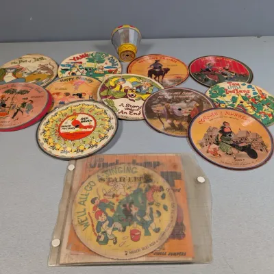 Sale Photo Thumbnail #380: Collection of vintage Red Raven Magic Mirror animated records and viewer, featuring colorful illustrated children's picture discs from the mid-20th century.