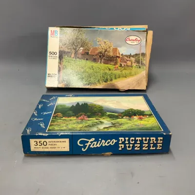 Sale Photo Thumbnail #226: Two vintage boxed jigsaw puzzles, including a 500-piece Milton Bradley Croxley series puzzle and a 350-piece Fairco Picture Puzzle featuring scenic landscape scenes.