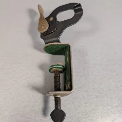 Sale Photo Thumbnail #329: Vintage metal C-clamp attachment with green felt padding and a top quick-release lever mechanism.