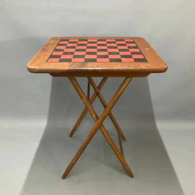 Sale Photo Thumbnail #267: Vintage wooden folding game table with a painted red and black checkerboard top, showing visible wear to the finish.