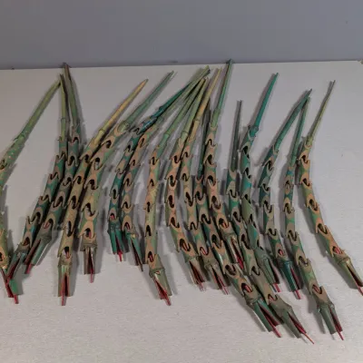 Sale Photo Thumbnail #164: Collection of vintage flexible wooden articulated snakes, painted in green, tan, and red accent details.