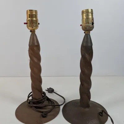 Sale Photo Thumbnail #57: Pair of vintage table lamps featuring carved spiral wooden shafts, metal bases, and brass light sockets.