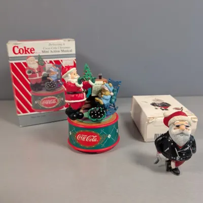 Sale Photo Thumbnail #140: Vintage Coca-Cola "Delivering a Coca-Cola Christmas" mini action musical box and a biker Santa Claus Christmas ornament, both in original packaging.