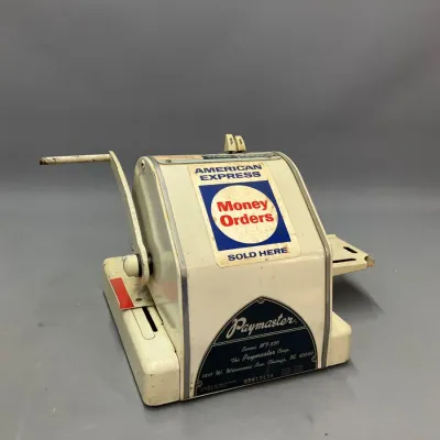 Sale Photo Thumbnail #213: Vintage Paymaster Series MT-550 check writer machine featuring American Express Money Orders branding and a manual side-crank handle.