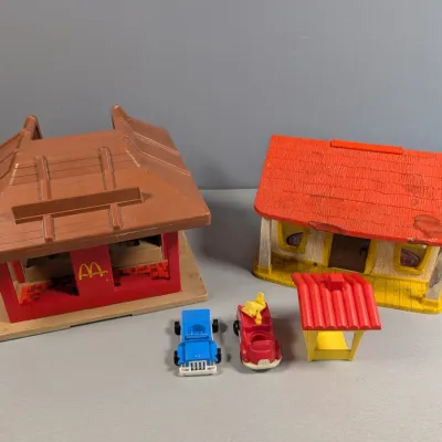 Sale Photo Thumbnail #367: Vintage Fisher-Price Little People McDonald's restaurant and Play Family house playsets with toy vehicles and accessories, showing light play wear.