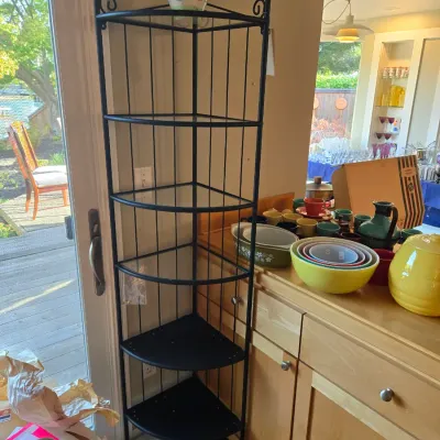 Sale Photo Thumbnail #91: Tall black wrought iron corner baker's rack