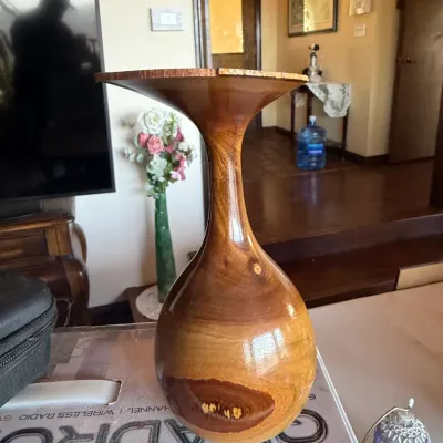 Hand-turned natural edge wood vase featuring a glossy finish and prominent wood grain detail.