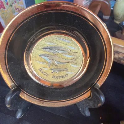 Vintage Maui, Hawaii souvenir decorative mini plate featuring an embossed brass-tone whale design in the center with a copper-tone rim.