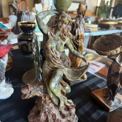 Carved green stone figurine depicting a classical water bearer woman holding an urn above her head.