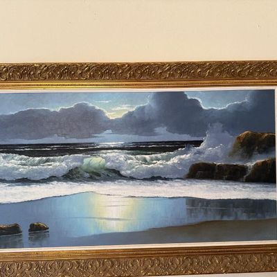 Sale Photo Thumbnail #91: Framed original oil painting depicting crashing ocean waves along a rocky coast under a moonlit sky, presented in an ornate gilt wood frame.