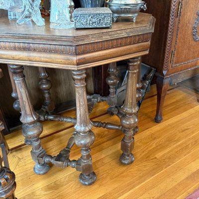 Sale Photo Thumbnail #317: Antique Jacobean-style carved oak octagonal accent table featuring detailed turned legs and a lower stretcher base.