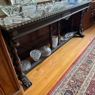 Sale Photo Thumbnail #152: Traditional dark wood sofa console table with carved detailing, displayed with a collection of cut crystal and glassware including a blue glass basket.