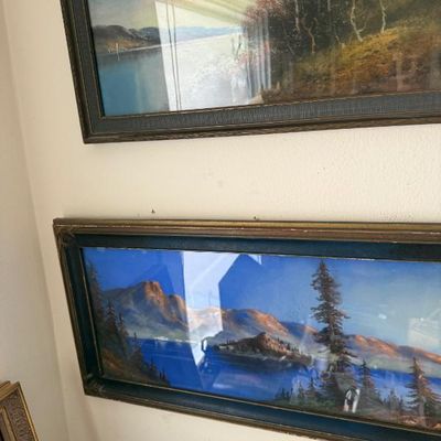 Sale Photo Thumbnail #117: Pair of vintage framed landscape prints under glass, featuring scenic mountain and lake views in dark wooden frames.