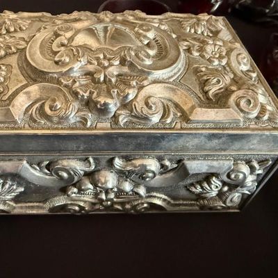 Sale Photo Thumbnail #2: Vintage ornate silver-plated jewelry or trinket box featuring detailed repoussé floral scrollwork and Baroque-style motifs.