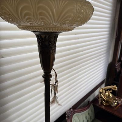 Sale Photo Thumbnail #279: Vintage floor lamp featuring an ornate dark metal pole and a large molded cream glass bowl shade.