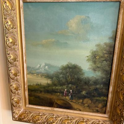 Sale Photo Thumbnail #94: Framed vintage oil painting depicting a pastoral landscape with two figures, housed in an ornate carved gold-tone frame.