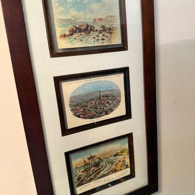 Sale Photo Thumbnail #118: Framed set of three vintage advertising and landscape trade cards, presented in a dark wood frame with white matting.