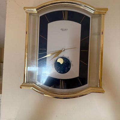 Sale Photo Thumbnail #354: Vintage Seiko Quartz brass wall clock featuring a moon phase sub-dial and gold-tone hands.