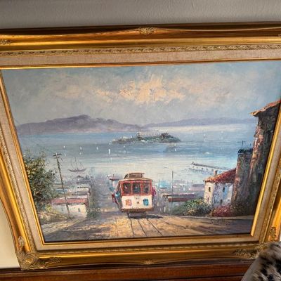 Sale Photo Thumbnail #63: Framed impressionist oil painting depicting a San Francisco cable car heading down a hill toward the bay with Alcatraz in the background, set in an ornate gilded wood frame with a linen liner.