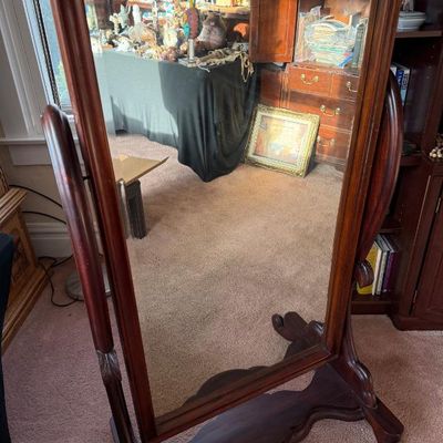 Sale Photo Thumbnail #245: Traditional dark wood cheval floor mirror featuring an adjustable tilting frame on a carved trestle base.