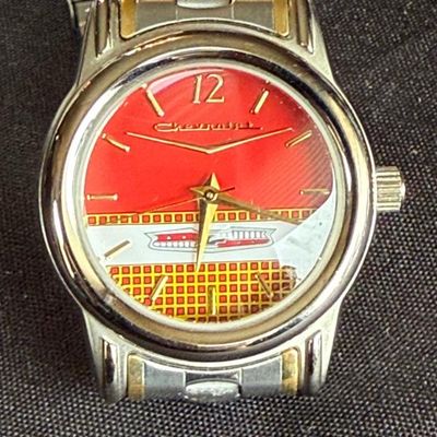 Sale Photo Thumbnail #37: Chevrolet classic logo wristwatch featuring a red dial with a vintage car grille design and two-tone link bracelet.