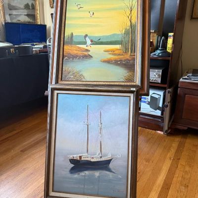 Sale Photo Thumbnail #77: Pair of vintage framed oil paintings, featuring a waterfowl scene above a sailboat on calm water, both in matching rustic wood frames with linen mats.
