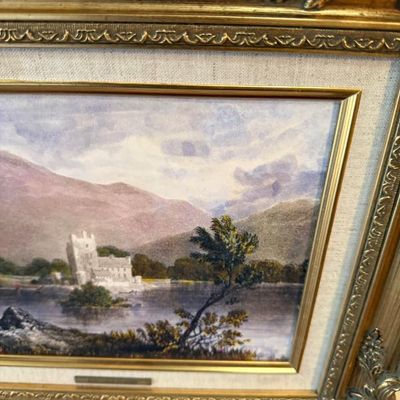 Sale Photo Thumbnail #101: Framed landscape art print featuring a castle on a lakefront with mountains, housed in an ornate giltwood frame with a linen mat board.