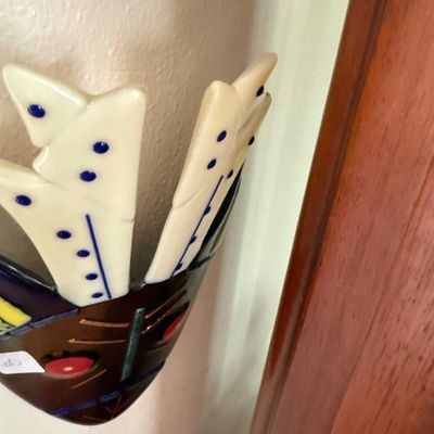 Sale Photo Thumbnail #232: Handcrafted fused glass mask wall sculpture with colorful feather-like details and facial features.